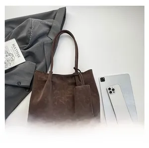 Deep coffee large tote bag with matching pouch shown next to a tablet and a book
