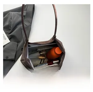 Top view of brown suede shoulder bag showing large interior capacity for daily essentials