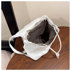 Detailed top view of white PU leather backpack with lace trim and spacious interior