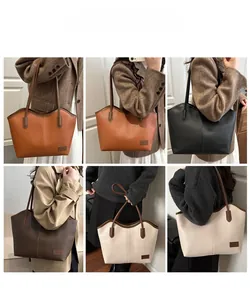 Detail view of large faux leather tote bags in four colors shown on a model