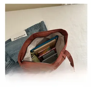 Top view of spacious brown corduroy tote bag interior with zipper and white lining