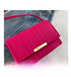 Close-up of fuchsia croco-embossed leather texture with elegant gold metal bar detail