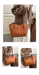 Detail view of brown lychee grain leather tote bag with elongated shoulder straps