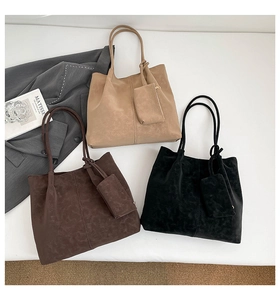 Flat lay of vintage tote bags in khaki, brown, and black with small pouches and matte texture
