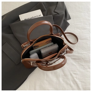 Detailed interior view of a brown leather crossbody bag showing spacious capacity and pockets