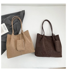 Flat lay of retro large tote bags in khaki and brown with mini wallets on white background