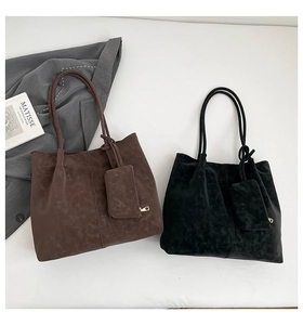 Detail of vintage matte suede tote bag set in dark brown and black colors