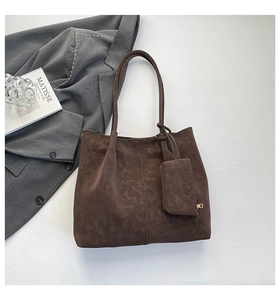 Detail shot of brown vintage tote bag with inner pouch and premium stitching texture