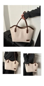 Detail view of large tote bag in beige and brown pebble leather with shoulder straps
