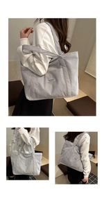 Lifestyle view of a large light blue corduroy tote bag with front pocket and shoulder straps