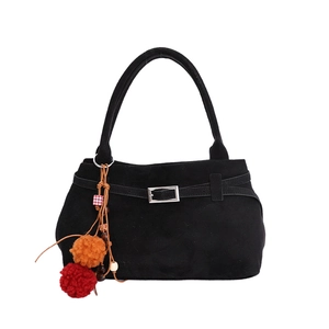 Black vintage suede tote bag with bohemian tassel charm and spacious minimalist design