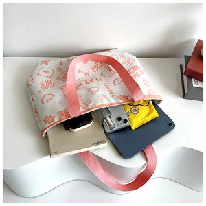 Top view of large floral canvas tote bag showing interior storage capacity with gadgets