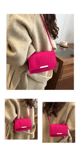 Detail of rose pink crocodile pattern faux leather handbag with golden metal buckle