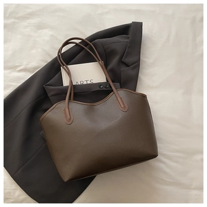 Close-up of vintage dark brown pebble leather tote bag with fine stitching details