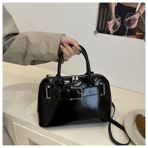 Fashionable black patent leather shell bag with silver buckle and adjustable strap