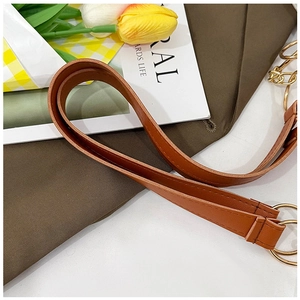 Detail of brown leather replacement shoulder strap with gold metal ring hook and stitching