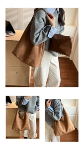 Brown frosted leather tote bag and matching pouch shown in a minimal interior setting