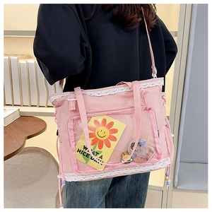 Pink lace crossbody bag with transparent mesh pocket and sweet floral charm on model