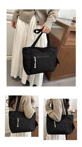 Détail du grand sac cabas noir en velours côtelé avec poche zippée et cordon de coton blanc