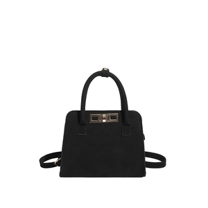 Black matte trapezoid handbag with gold twist lock and adjustable shoulder strap