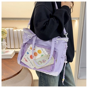 Lilac ita bag detail with lace trim and clear PVC window shown on shoulder