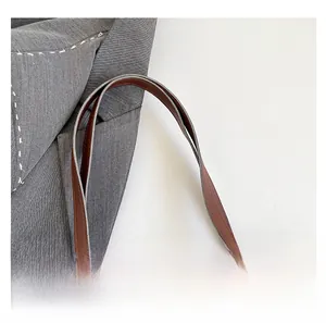 Close-up of brown PU leather tote bag handle showing fine stitching and premium texture