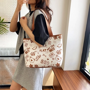 Minimalist white tote bag with brown bear graffiti print and large capacity for commuting