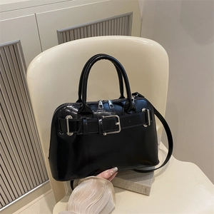 Chic glossy black leather handbag with silver hardware and adjustable shoulder strap
