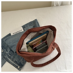 Internal view of caramel corduroy tote bag showing large capacity for books and tablet