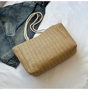 Macro detail of woven tote bag with cotton rope handles on white fabric background