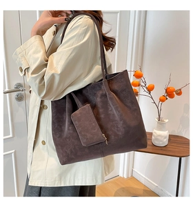 Mocha suede tote bag with matching detachable pouch shown with a beige trench coat