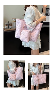 Detail of pink swan pattern tote bag set including a square inner pouch and leather handles