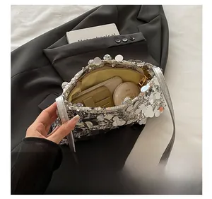 Detail view of silver sequin shoulder bag showing internal card slots and spacious capacity