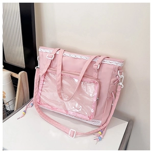 Detailed view of pink canvas tote bag with transparent window and white lace trim
