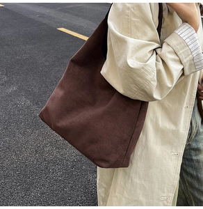 Detail of dark brown faux suede tote bag showing soft matte texture and large capacity