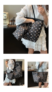 Detail of black tote bag set with pink pegasus print and matching zipper pouch
