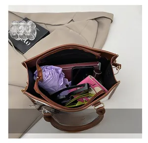 Macro detail showing the large interior capacity and storage compartments of the tote bag