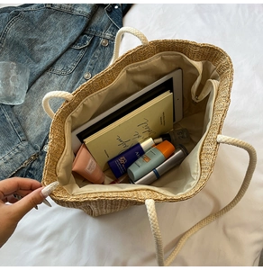 Top view of large straw woven tote bag showing spacious interior with zipper lining