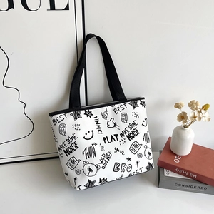 Minimalist canvas tote bag with black graffiti prints and sturdy handles in a Nordic setting