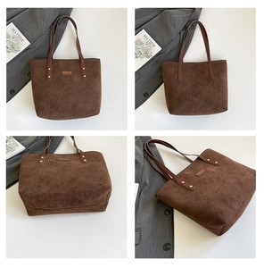 Detail view of a vintage dark brown frosted tote bag with minimalist gold fashion branding