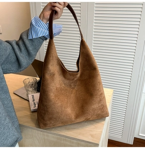 Detail of vintage matte brown leather tote bag showing hobo style and suede texture