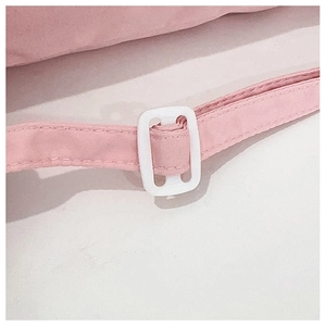 Detail of pink woven strap with white plastic buckle on transparent crossbody bag