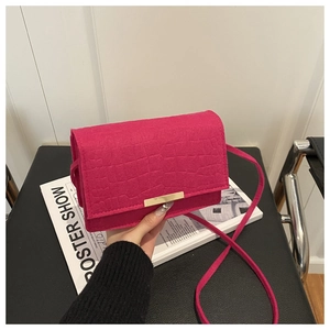 Detailed fuchsia faux leather bag with crocodile texture and golden metal buckle clasp