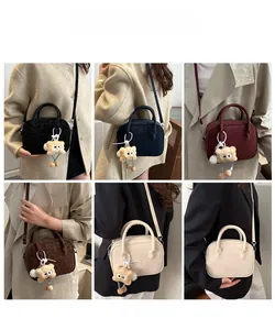 Detail view of stylish Boston bags in various colors featuring cute plush bear charms