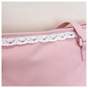 Detailed view of pink fabric bag featuring delicate white lace trim and adjustable strap
