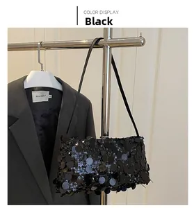 Detail of elegant black sequin evening bag hanging on a rack for a premium aesthetic look