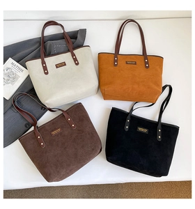 Detailed macro view of four suede tote bags in cream, tan, brown and black colors