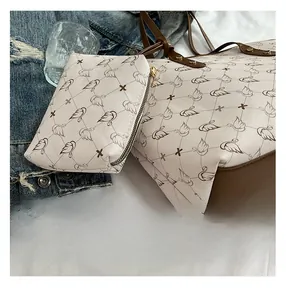 Close-up of printed tote bag and pouch set with vintage swan pattern on white fabric
