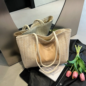 Large beige woven straw tote bag with rope handles and leather fashion patch detail