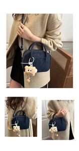 Detail of dark blue leopard print crossbody bag featuring a cute plush doll charm
